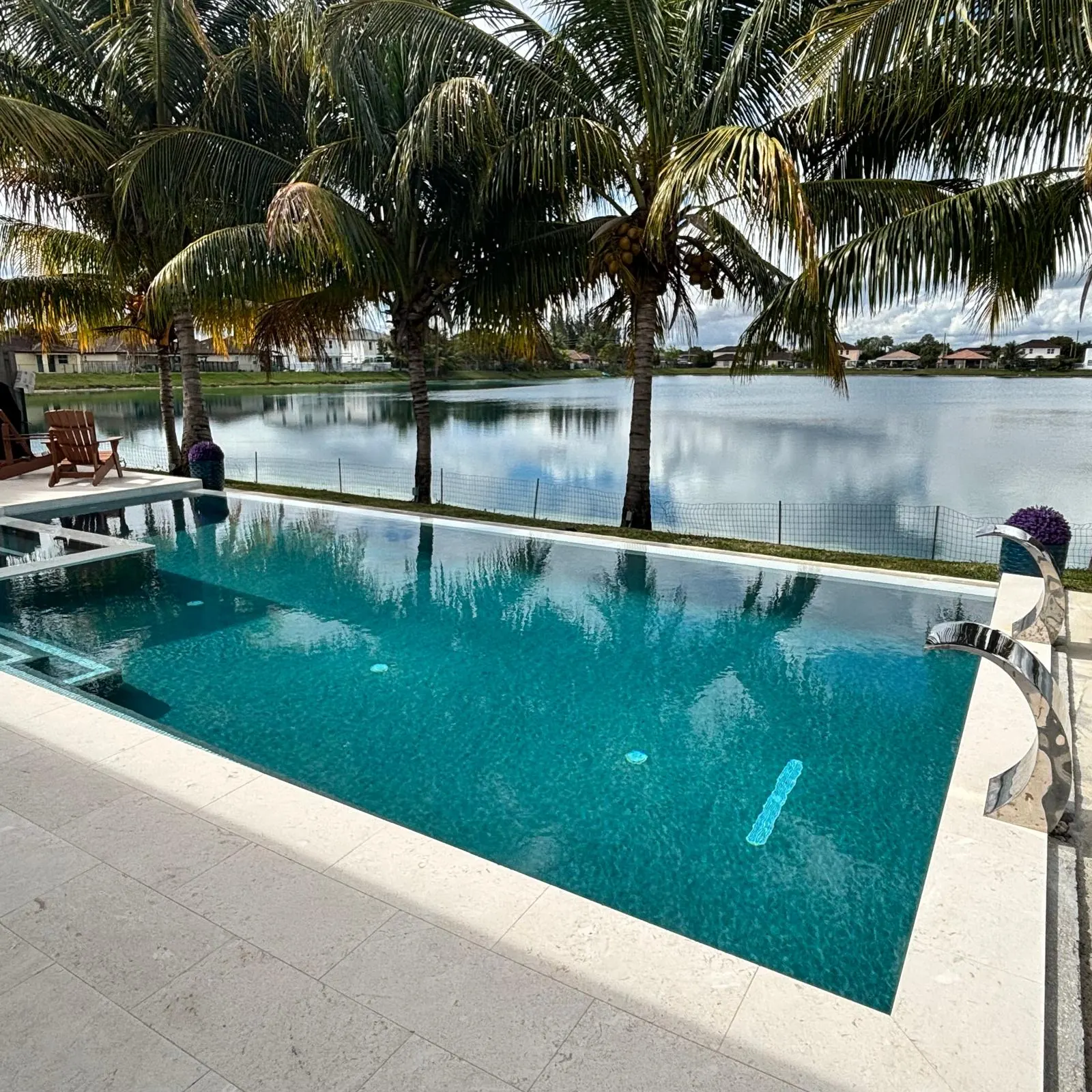 Lakefront pool and spa on a sunny day