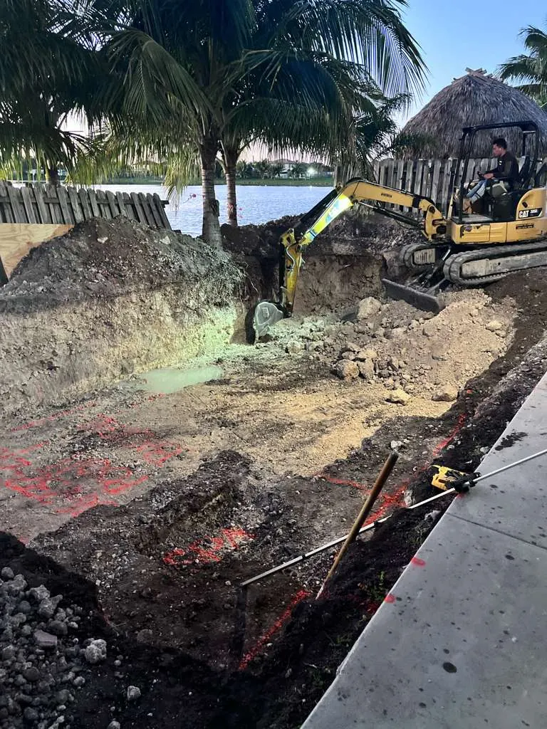 Pool dig under work lights at night